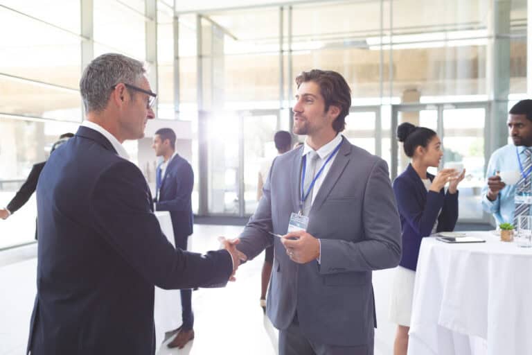 Side view of caucasian happy business people shaking hand during a seminar